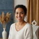 Smiling young woman's headshot, conveying trust and happiness.